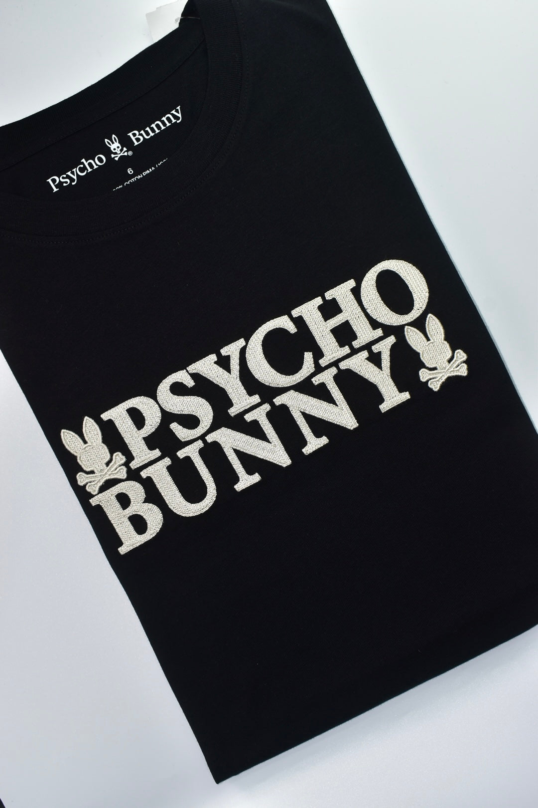 CAMISETA PSYCHO BUNNY COLECCION ORIGINAL NEGRO ESTAMPADO BEIGE TEJIDO