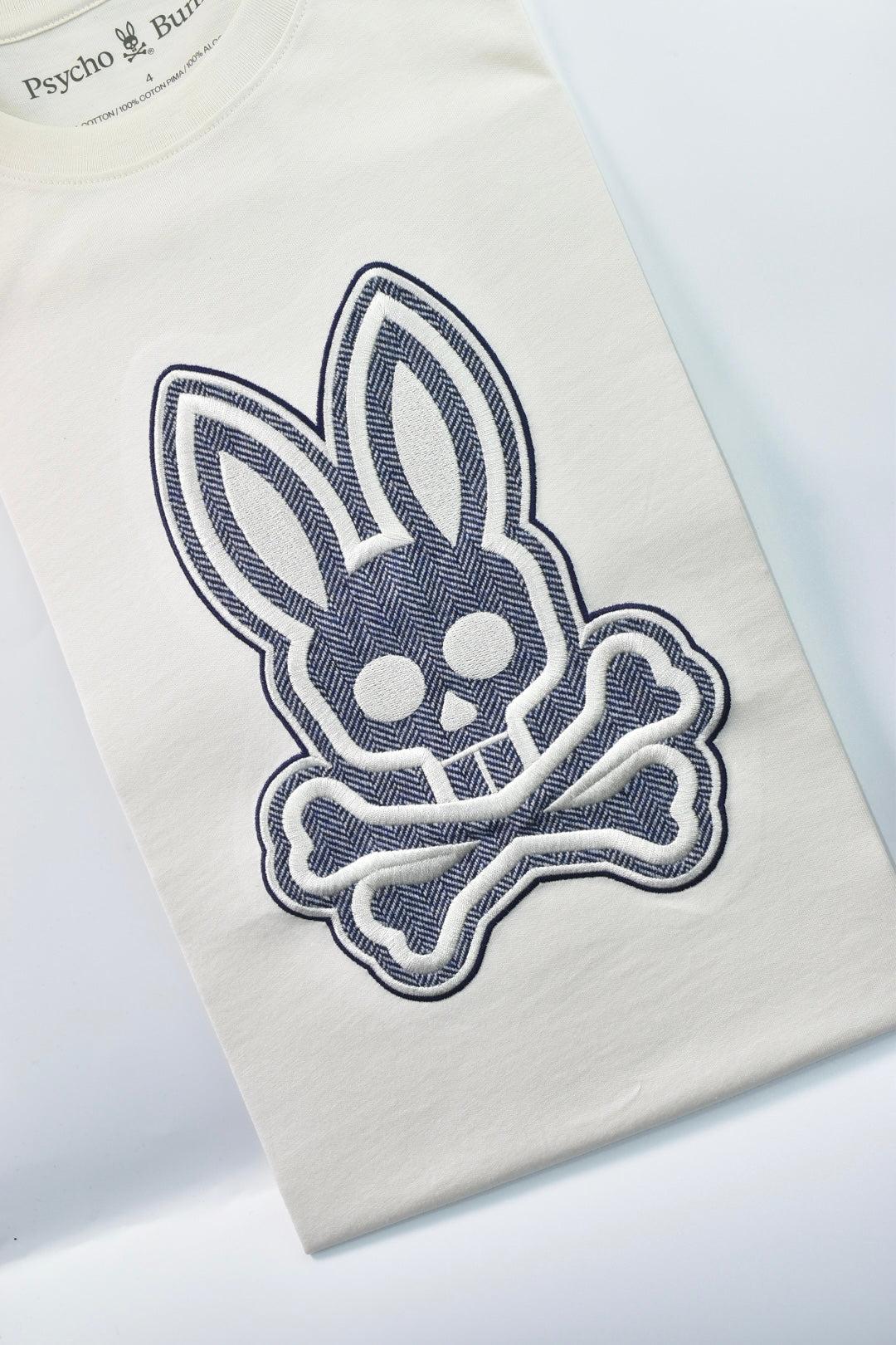 CAMISETA PSYCHO BUNNY COLECCION ORIGINAL BLANCO ESTAMPADO RAYAS AZUL BORDADO PLATA